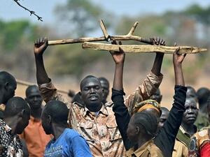 South Sudan trainee soldiers for a new unified army raise their wooden rifles above their heads while attending a reconciliation program on January 31, 2020, meant at ending bloodshed in the country. (AFP)