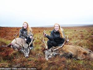 Rikke (left) and Trine (right) Jacobsen, from Ry in Denmark, post pictures of themselves smiling as they stand over the animal corpses. They are pictured with stags in the Scottish Highlands. (Daily Mail)