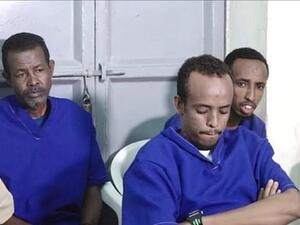 Abdifatah Abdirahman Warsame (pictured centre) and Abdishakur Mohamed Dige were shot by a firing squad in Bossasso town square today after being found guilty of the attack. (Daily Mail)