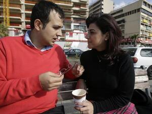 Kholoud Sukkariyeh (R) and Nidal Darwish, who got married in defiance of Lebanon's ban on civil unions, pose for a picture next to Beiurt's landmark Pigeon Rock on January 25, 2013. AFP
