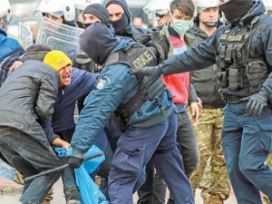 Riot police scuffle with migrants during a demonstration outside the municipal theatre of the city of Mytilene, on the island of Lesbos, on Tuesday. — AFP photo