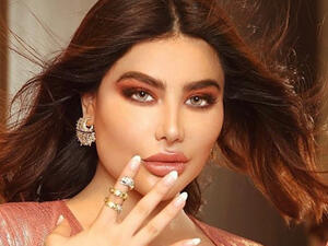 Angie posed along with a giant red teddy bear in a sexual way (source: @singerangiekhoury Instagram)