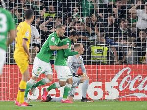 Real Betis' French midfielder Nabil Fekir (2R) celebrates his goal against FC Barcelona at the Benito Villamarin stadium in Seville on Feb 9, 2020. CRISTINA QUICLER / AFP