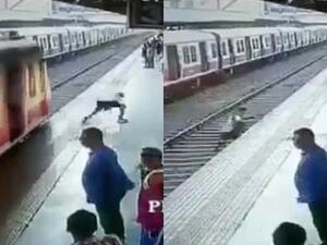 The boy ran across the tracks and narrowly missed the train in Thane, on the outskirts of Mumbai, India. He was a second in front of the train. (Video Screenshots)