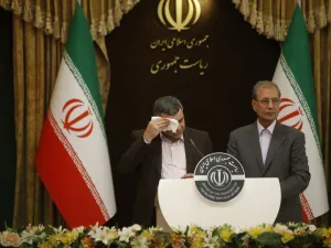 Iranian Deputy Health Minister Iraj Harirchi (L) wipes the sweat off his face, during a press conference with the Islamic republic's government spokesman Ali Rabiei in the capital Tehran on February 24, 2020. AFP/File