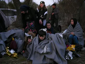 Migrants sit on a beach covered with blanket near Skala Sykamineas on the Greek Lesbos island after crossing the Aegean sea between Turkey and Greece on March 1, 2020. Greece has blocked nearly 10,000 migrants trying to enter at the Turkey border over the past 24 hours, a Greek government source said Sunday. "From 0600 (0400 GMT) Saturday morning to 0600 Sunday morning, 9,972 illegal entrances have been averted in the Evros area," a government source said, referring to the northeastern region along the Turk