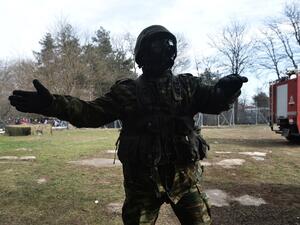 Greek army officer gestures on the Greek side of the Greece-Turkey border near Kastanies, on March 2, 2020. Greece was on a state of alert on March 1, 2020 as it faced an influx of thousands of migrants seeking to cross the border from Turkey, with locals fearing a new immigration crisis. More than 13,000 migrants have gathered on the Turkish side of the river which runs 200 kilometres (125 miles) along the frontier and separates them from Greece and therefore the European Union. The flow of migrants from T