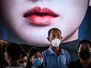 Commuters, wearing facemasks amid fears of the spread of the COVID-19 novel coronavirus (AFP)