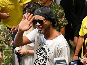 Brazilian ex-football star Ronaldinho Gaucho waves upon arriving at Silvio Pettirossi International Airport in Luque, near Asuncion, on March 4, 2020. Ronaldinho arrived in Paraguay to present his latest book "Genio en la Vida" and a health programme for girls and boys.  Norberto DUARTE / AFP