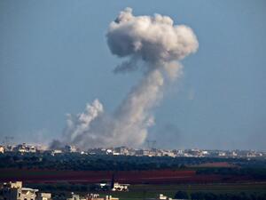 A picture taken from Binnish shows smoke billowing above buildings during pro-regime forces air strikes on rebel-held areas surrounding the regime-controlled town of Saraqeb, in the northwestern Idlib province on March 4, 2020. Muhammad HAJ KADOUR / AFP