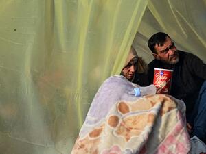 Migrants sit in a make shift shelter as they gather near the Tunca river waiting to resume their efforts to enter Europe near Pazarkule border gate in the city of Edirne, northwest Turkey on March 5, 2020. EU members on March 4, 2020 rejected what they said is Turkey's use of desperate migrants to pressure its neighbours -- and strongly backed Greece's border crackdown. The EU has scrambled to respond to the surge of migrants at the Greek border, where authorities say some 24,000 were stopped from entering 