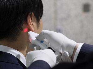 A visitor to the Tokyo Metropolitan Government office has his body temperature checked at the reception of the building in Tokyo on March 5, 2020. Japan will quarantine all passengers arriving from China and South Korea, the country's prime minister said on March 5, as the government ramps up measures to contain an outbreak of the COVID-19 coronavirus. Kazuhiro NOGI / AFP
