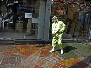 Iranian fire fighters and municipality workers disinfect a street in the capital Tehran for corona virus COVID-19 on March 5, 2020. Iran today reported 15 new deaths from the novel coronavirus and 591 fresh cases in the past 24 hours, bringing the toll to 107 dead and 3,513 infected. STR / AFP