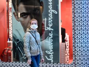 A passenger wearing a protective face mask looks on in Milano Centrale railway station in Milan on March 8, 2020, after millions of people were placed under forced quarantine in northern Italy as the government approved drastic measures in an attempt to halt the spread of the COVID-19 outbreak, caused by the novel coronavirus that is sweeping the globe. On top of the forced quarantine of 15 million people in vast areas of northern Italy until April 3, the government has also closed schools, nightclubs and c