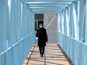 An Iranian pedestrian walks while wearing a protective mask in Tehran on March 10, 2020 amid the spread of coronavirus in the country. Iran today reported 54 new deaths from the novel coronavirus in the past 24 hours, the highest single-day toll since the start of the country's outbreak.  ATTA KENARE / AFP