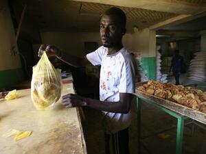 A Sudanese baker sells bread at a bakery in Omdourman on March 11, 2020. Sudan's economy has sunk into a deep crisis since the fall of longtime autocrat Omar al-Bashir almost a year ago, risking collapse and social unrest in a country in political transition. Anti-government protests erupted in Sudan in late 2018 against a government decision to triple bread prices. Bashir's ouster last April led to months of talks, also against a backdrop of mass protests, that eventually produced a transitional government