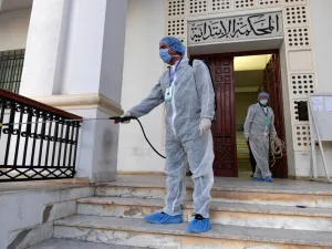 Tunisian public health workers disinfect the entrance to the Ariana tribunal near the capital Tunis, to prevent the spread of the coronavirus COVID-19, on March 12, 2020. FETHI BELAID / AFP