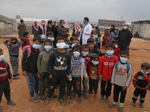 Doctor Ali Ghazal holds an awareness workshop on Coronavirus (COVID-19) at a camp for displaced people in Atme town in Syria's northwestern Idlib province, near the border with Turkey, on March 14, 2020. AAREF WATAD / AFP`