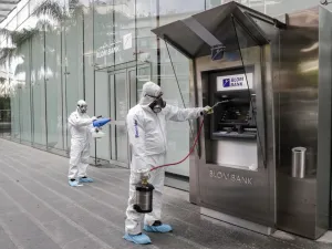 Employees of a private company spray sanitising liquid around a bank in a bid to limit the spread of the cornonavirus Civid-19, in the Lebanese capital Beirut on March 15, 2020. ANWAR AMRO / AFP