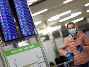 A woman wearing a face mask walks at the airport in Palma de Mallorca on March 16, 2020. Spain has registered nearly 1,000 new COVID-19 infections over the past 24 hours, raising the total number of cases to 8,744. AFP/File