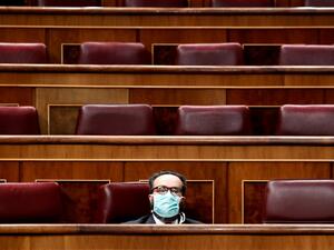 Spanish far-right Vox party's MP Jose Maria Sanchez Garcia wears a face mask as a protective measure during a session at the Spanish Parliament in Madrid to explain the Government's declaration of a State of Alert and the measures taken to mitigate the coronavirus COVID-19 consequences on March 18, 2020. The Prime Minister, Pedro Sanchez, warned today that "the hardest is yet to come" when the number of people in hospitals due to the coronavirus increases, before a practically empty Congress to avoid spread