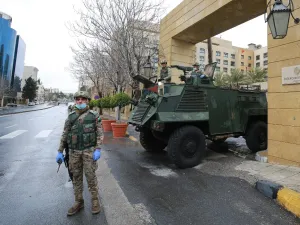 Jordanian soldiers keep watch on March 18, 2020 at an empty avenue in the capital Amman as Jordan takes measures to fight the spread of the coronavirus COVID-19. Khalil MAZRAAWI / AFP