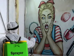 A volunteer disinfects a shop in Baghdad's Bayaa neighbourhood on March 21, 2020 as a preventive measure against the spread of the coronavirus COVID-19. AHMAD AL-RUBAYE / AFP