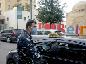 A Lebanese security officer mans a checkpoint to implement a curfew on motorcycles and vehicles with more than two passengers in the capital Beirut, on March 23, 2020, amid lockdown measures to curb the spread of the coronavirus epidemic. PATRICK BAZ / AFP