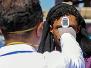 A health official checks the body temperature of man at the entrance of the city of Taez in southwestern Yemen on March 23, 2020 amid concerns over the spread of the COVID-19 novel coronavirus. Ahmad AL-BASHA / AFP