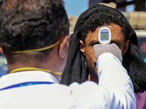 A health official checks the body temperature of man at the entrance of the city of Taez in southwestern Yemen on March 23, 2020 amid concerns over the spread of the COVID-19 novel coronavirus. Ahmad AL-BASHA / AFP