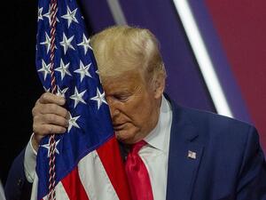 NATIONAL HARBOR, MARYLAND - FEBRUARY 29: President Donald Trump rests his head on the flag of the United States of America at the annual Conservative Political Action Conference (CPAC) at Gaylord National Resort & Convention Center February 29, 2020 in National Harbor, Maryland. Conservatives gather at the annual event to discuss their agenda. Tasos Katopodis/Getty Images/AFP TASOS KATOPODIS / GETTY IMAGES NORTH AMERICA / AFP