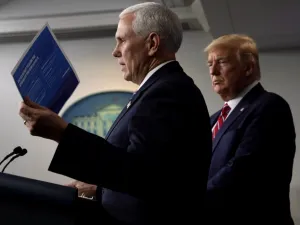 U.S. Vice President Mike Pence speaks as President Donald Trump listens during a news briefing on the latest development of the coronavirus outbreak in the U.S. at the James Brady Press Briefing Room at the White House March 20, 2020 in Washington, DC. ALEX WONG / GETTY IMAGES NORTH AMERICA / AFP