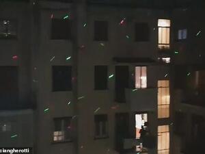 Locals in Rome leaned out of their windows to shine the lights onto the apartments of their neighbours as part of a communal disco on Sunday evening, on the sixth night of lockdown. (Video Screenshot)
