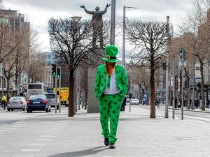 St Patrick's Day 2020 in Dublin: A man celebrating St Patrick's Day strolls in the O'Connell Street area of Dublin today as St Patrick's Day festivities are cancelled (AFP)