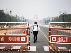 A man walks on a closed road leading to the Presidential Palace in New Delhi on March 24, 2020. India has instated a government-imposed lockdown for 30 days. Jewel Samad/AFP via Getty Images