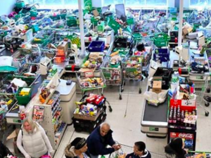 Trolleys piled high for delivery are seen as shoppers queue at the checkout of a supermarket in London on Mar 14, 2020, as consumers worry about product shortages, leading to the stockpiling of household products due to the outbreak of the novel coronavirus COVID-19. (Photo: AFP)