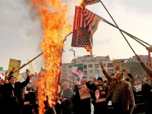 Iranian pro-government demonstrators burn makeshift US flags in Tehran. (AFP)
