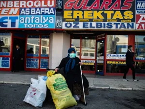 A woman wearing a protective face mask waits at the Esenler bus terminal in Istanbul, on March 14, 2020, during the outbreak of COVID-19, the new coronavirus. Turkey will halt flights with nine European countries the transport minister said on March 13, after having already shut all schools for two weeks and bar spectators from football matches through April, as part of Ankara's bid to contain the spread of the new coronavirus. Yasin AKGUL / AFP
