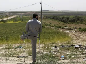 A disabled Palestinian man stands during an event marking Land Day near the Israel-Gaza border as mass rallies planned to commemorate the event were cancelled amid concerns about the spread of coronavirus disease (COVID-19), east of Gaza City, on March 30, 2020. MOHAMMED ABED / AFP