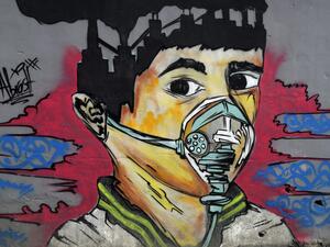 A picture taken on Mach 30, 2020 shows a mural depicting a mask-clad boy in front of the Zouk Thermal Power Plant, north of the Lebanese capital Beirut. JOSEPH EID / AFP