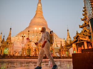 A volunteer sprays disinfectant in Shwedagon Pagoda compound as a preventive measure against the COVID-19 coronavirus, in Yangon on March 31, 2020. Myanmar reported its first coronavirus death -- a 69-year-old man who returned to the country in mid-March after receiving cancer treatment in Australia. Ye Aung Thu / afp