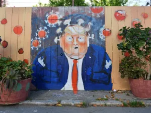 A mural painted on a fence depicts US President Donald Trump as the Coronavirus in San Francisco, California on April, 01, 2020. All 40 million residents of California were Thursday ordered to stay at home indefinitely in a bid to battle the coronavirus pandemic in the nation's most populous state. Josh Edelson / AFP