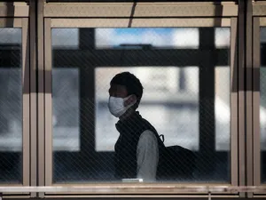 A man wearing a face mask amid concerns over the spread of the COVID-19 coronavirus walks in Shinagawa station in Tokyo on April 6, 2020. Behrouz MEHRI / AFP