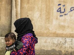 A Syrian child displaced from Ras al-Ain, a border town controlled by Turkey and its Syrian proxies, is pictured in a school turned into a shelter in the city of Hasakeh on April 5, 2020 in northeastern Syria. AFP