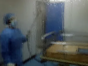 A man disinfects an intesive care isolation room at the Rafik Hariri public hospital in the Lebanese capital Beirut on April 7, 2020. The Mediterranean country announced a lockdown and closed its airport as of March 19 as part of measures to curb the spread of COVID-19, which has officially infected 548 people and killed 18 nationwide. JOSEPH EID / AFP