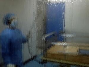 A man disinfects an intesive care isolation room at the Rafik Hariri public hospital in the Lebanese capital Beirut on April 7, 2020. The Mediterranean country announced a lockdown and closed its airport as of March 19 as part of measures to curb the spread of COVID-19, which has officially infected 548 people and killed 18 nationwide. JOSEPH EID / AFP