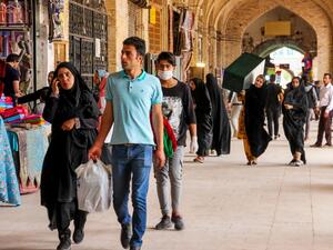 Iranians, some wearing personal protective equipment, walk past shops in the southeastern city of Kerman on April 11, 2020, amid the coronavirus (COVID-19) pandemic. Iran reported 125 new deaths from the novel coronavirus, raising the overall toll in the Middle East's worst-hit country to 4,357. Health ministry spokesman Kianoush Jahanpour told a news conference that 1,837 new infections had been confirmed in the past 24 hours, taking the total to 70,029. ISNA / AFP