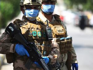 Iraqi soldiers stand at a checkpoint in the Adhamiya district of Baghdad on April 13, 2020 as Iraq imposed a curfew during the coronavirus COVID-19 pandemic. AHMAD AL-RUBAYE / AFP