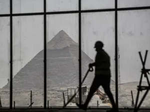 A picture taken on April 13, 2020, shows a view of the Great pyramid of Khafre (Chephren) seen through the scaffolding on the Grand Egyptian Museum (GEM), which is currently under construction, in Giza on the southwestern outskirts of the capital Cairo. Khaled DESOUKI / AFP