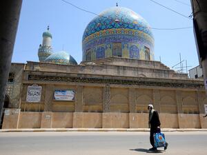 An Iraqi man walks past the closed Haydar-Khana mosque in the capital Baghdad on April 17, 2020, during the novel coronavirus pandemic crisis that urged authorities to shut down social gathering places in a bid to slow its spread among the population. AHMAD AL-RUBAYE / AFP